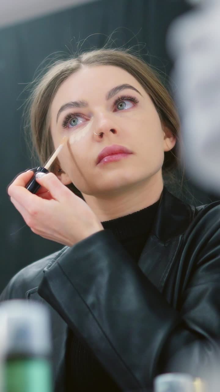 Young Woman Applies Concealer as Part of Her Makeup Routine