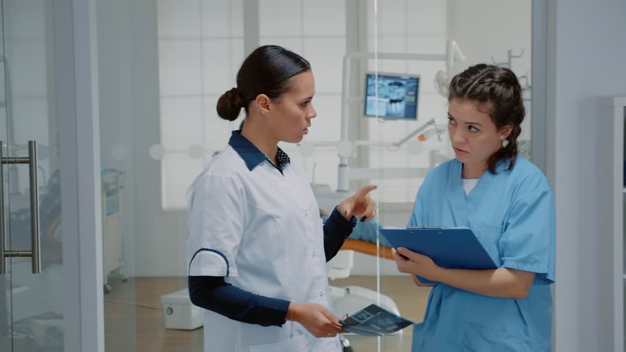 ortodontista y asistente usando escáner de rayos x de los dientes