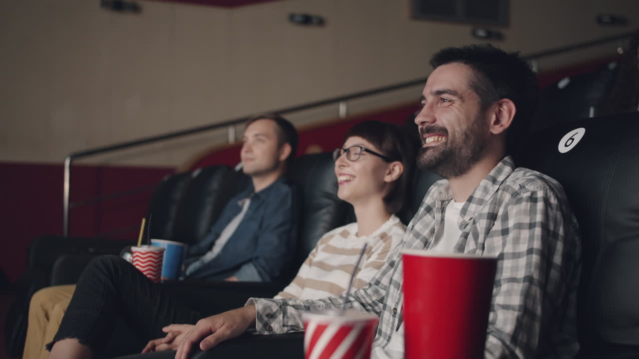 Friends enjoying a movie at the cinema