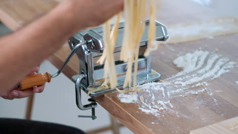 homemade pasta making: fresh dough through pasta machine