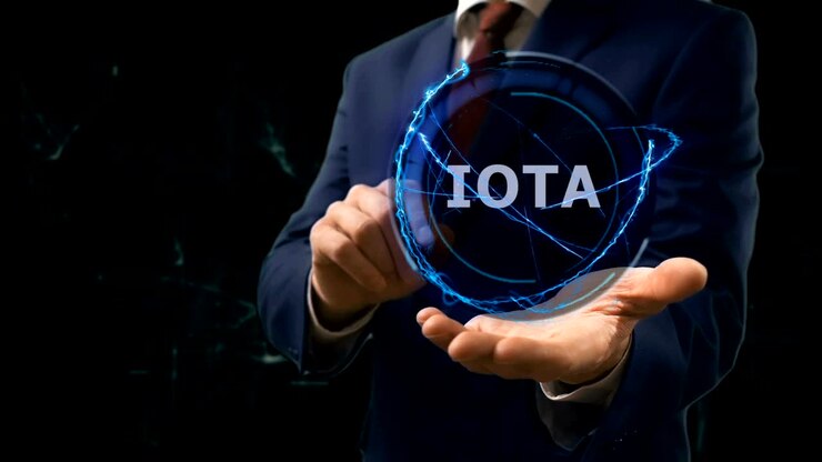 Businessman shows concept hologram Iota on his hand