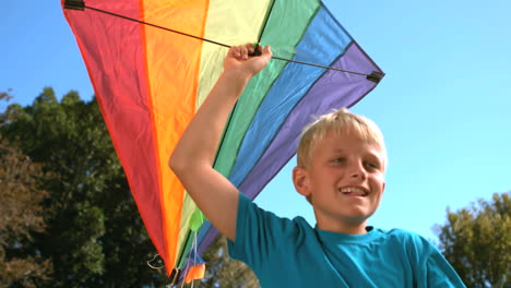 Young-boy-running-while-holding-a-kite