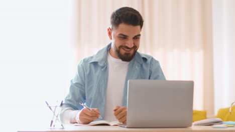 man working from home on a laptop