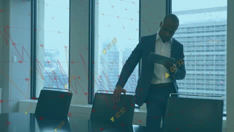 animation of financial data processing over african american businessman using tablet in office