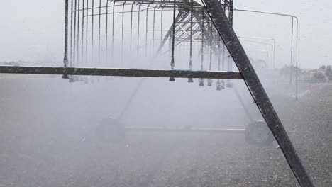 center pivot irrigation sprinkler system watering farm field crops in punjab