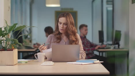 Business-woman-working-with-papers.-Serious-worker-looking-problems-in-documents