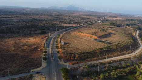 Aerial-view-of-scenic-narrowed-road-in-the-Vietnam-countryside-with-plowed-land-in-phan-rang,-ninh-thuan,-nui-chua