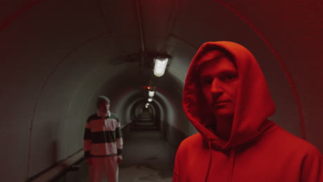 portrait of young parkourists in dark tunnel