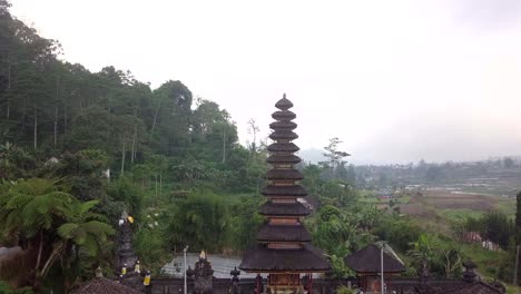 drone video of entrance to hindu temple in bali with lush green nature background. traveling ancient culture