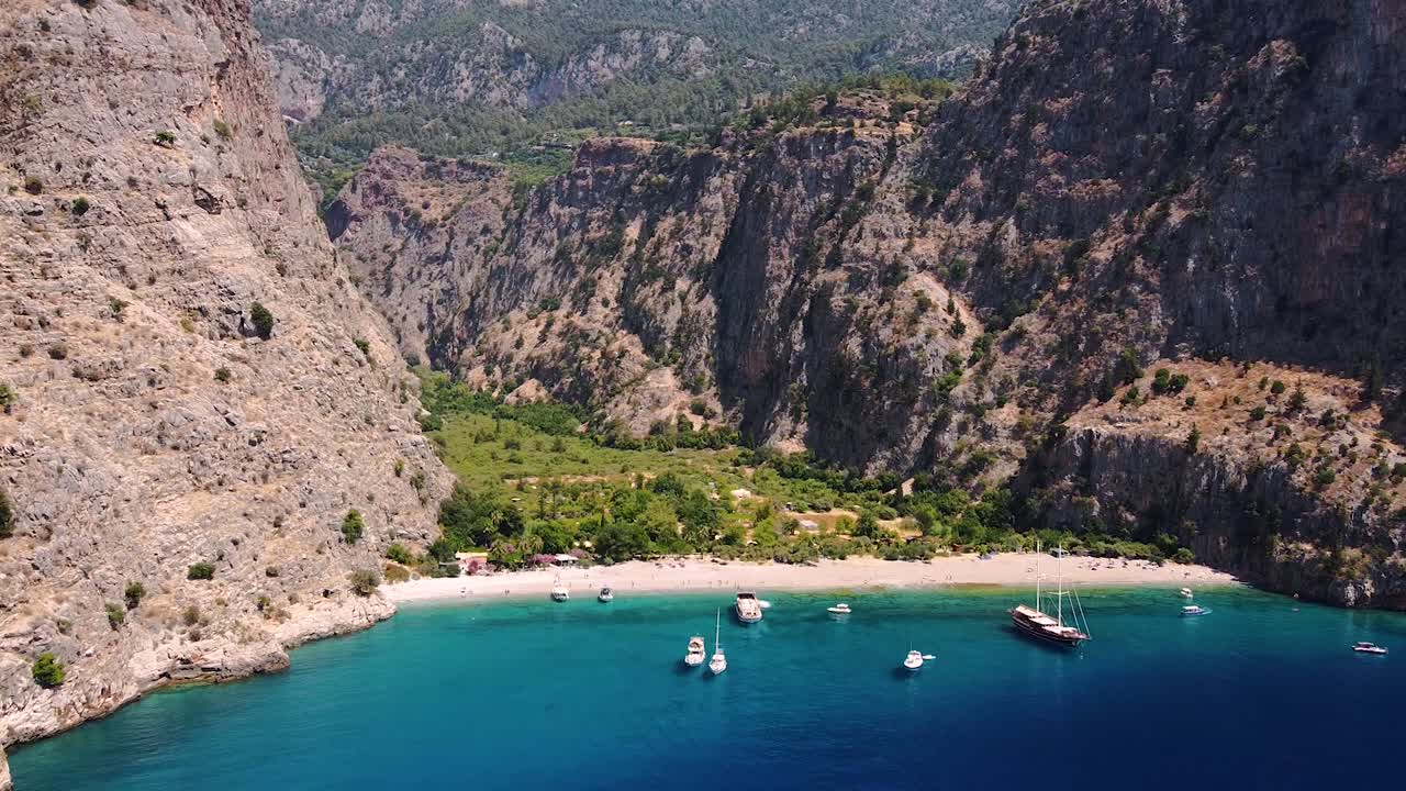 Aerial dolly shot approaching paradisiacal sandy beach in Turkey