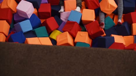Kids having fun in a colorful indoor trampoline park with foam pit