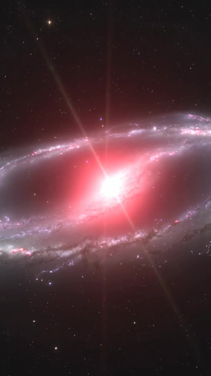 Video verticale: Galassia inclinata che si illumina, con il nucleo che si schiarisce, bracci e fasce di polvere nello spazio