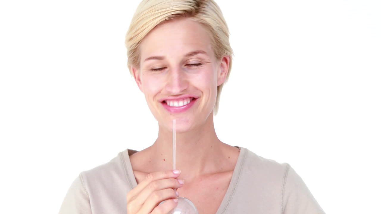 Pretty blond woman drinking vegetable juice 