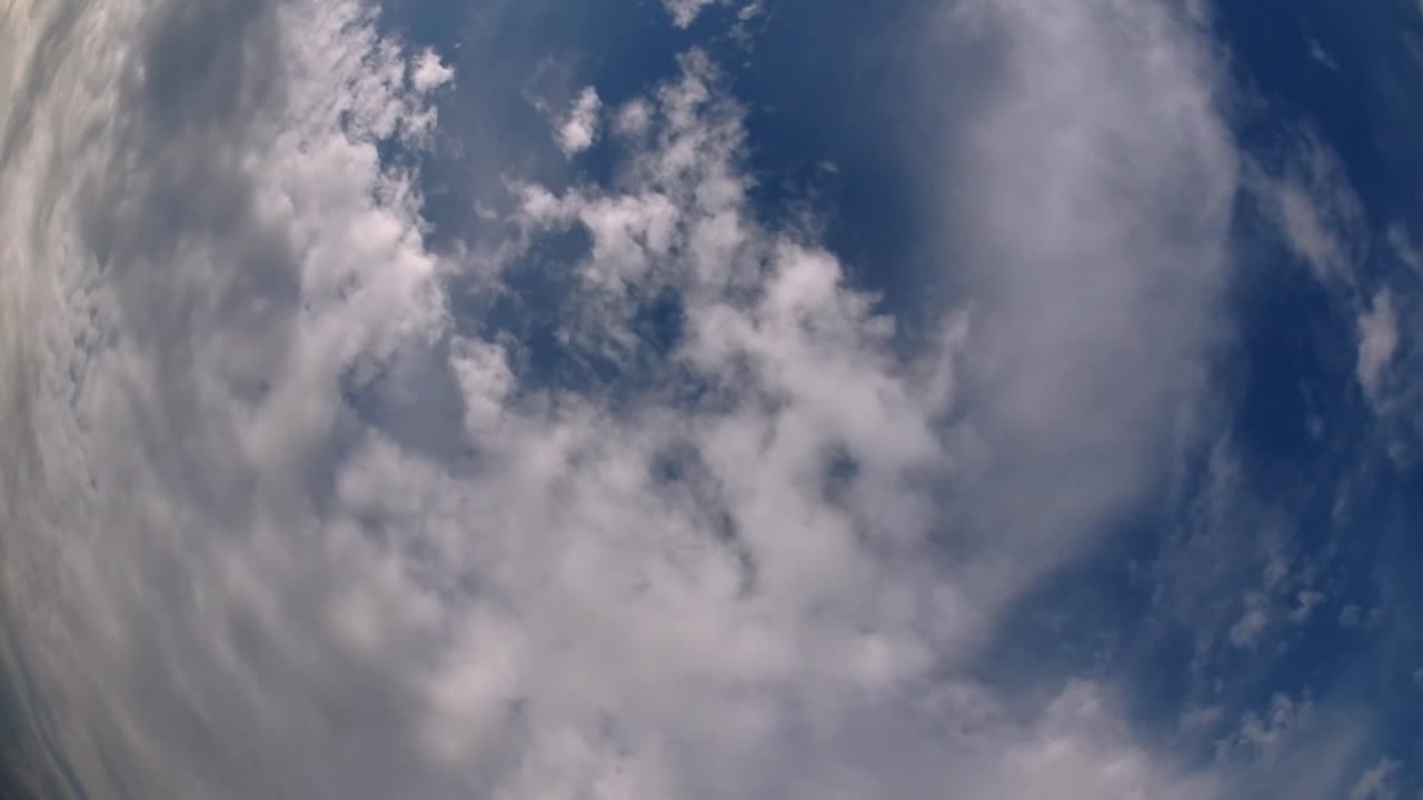 Blue sky and layer of clouds moving about in a fine sunny afternoon