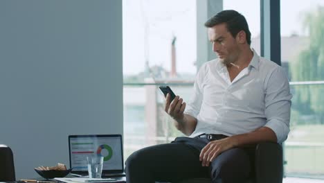 Business man looking mobile phone. Male professional waiting phone call.