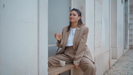 business woman sipping tea in open air coffeehouse. relaxed girl resting