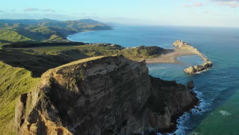 Aerial-dolly-out-shot-of-Castlepoint-beach,-New-Zealand-Coastline-during-summer-season