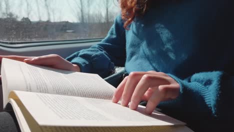 university student studies book traveling by train