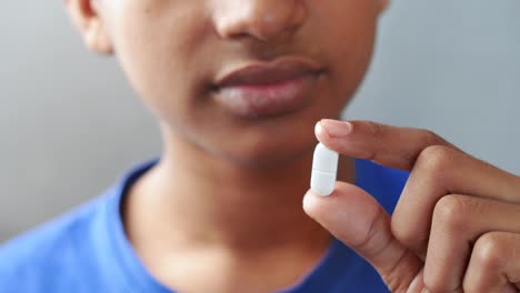 close up of man hand holding pills with copy space