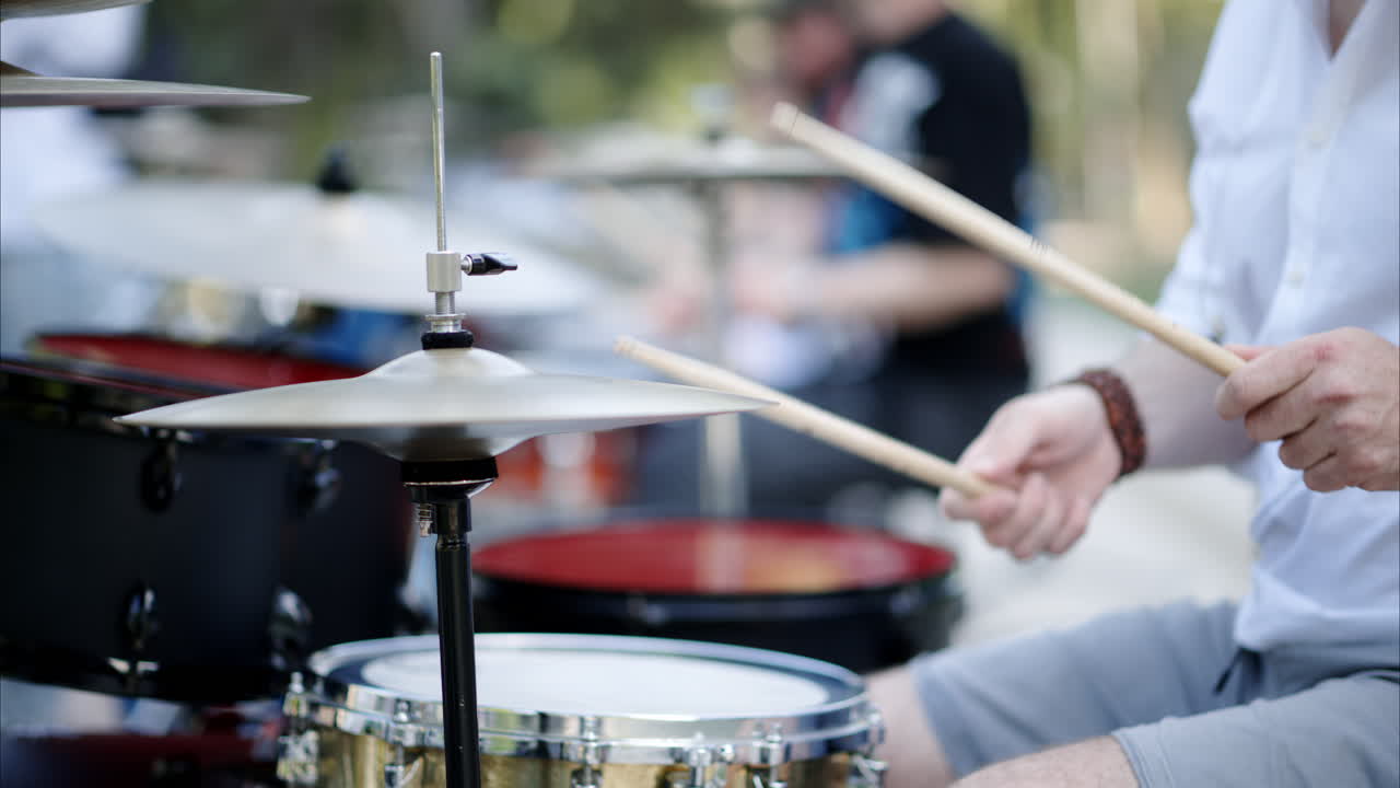 Close up of man playing the drums outside
