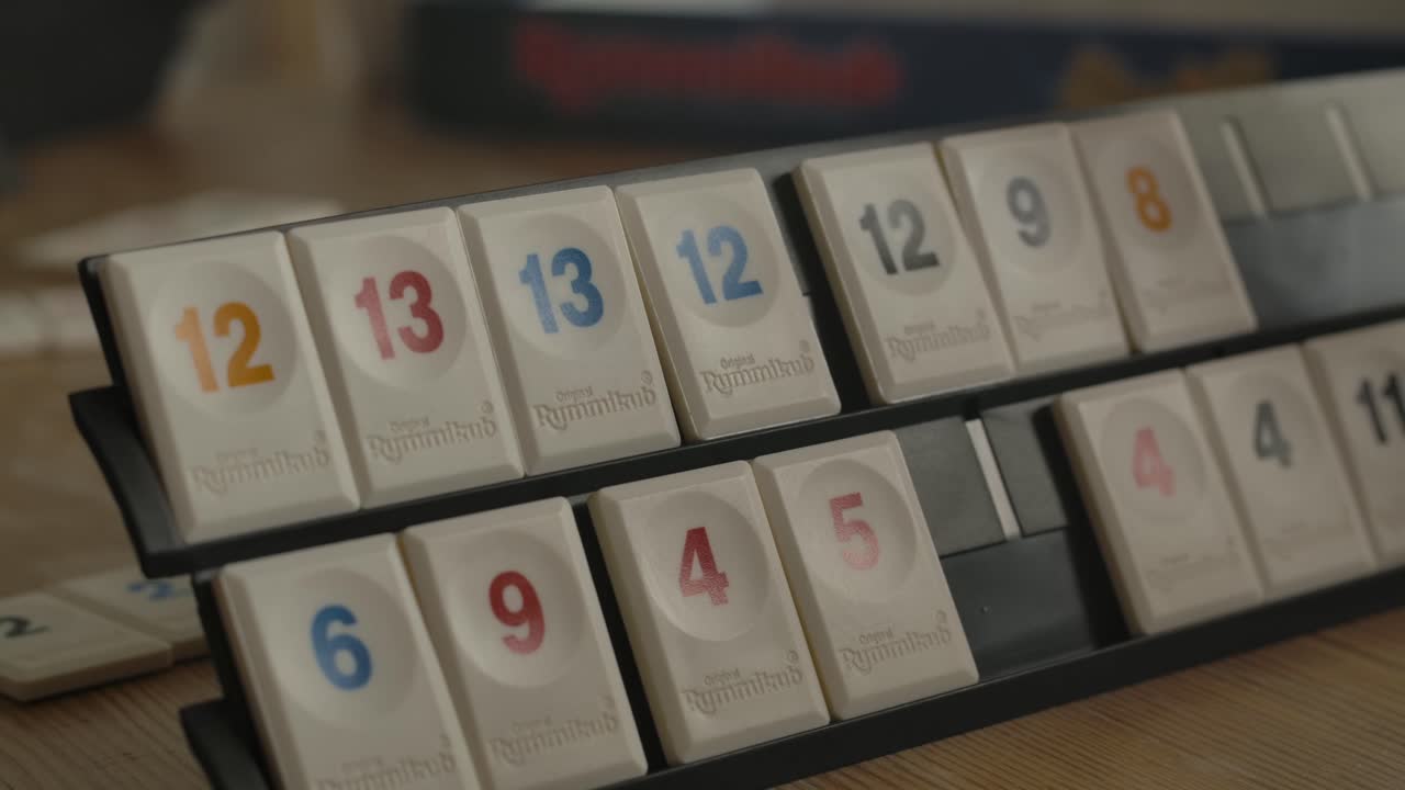 Close up view of person playing Rummikub, filmed handheld in 4k