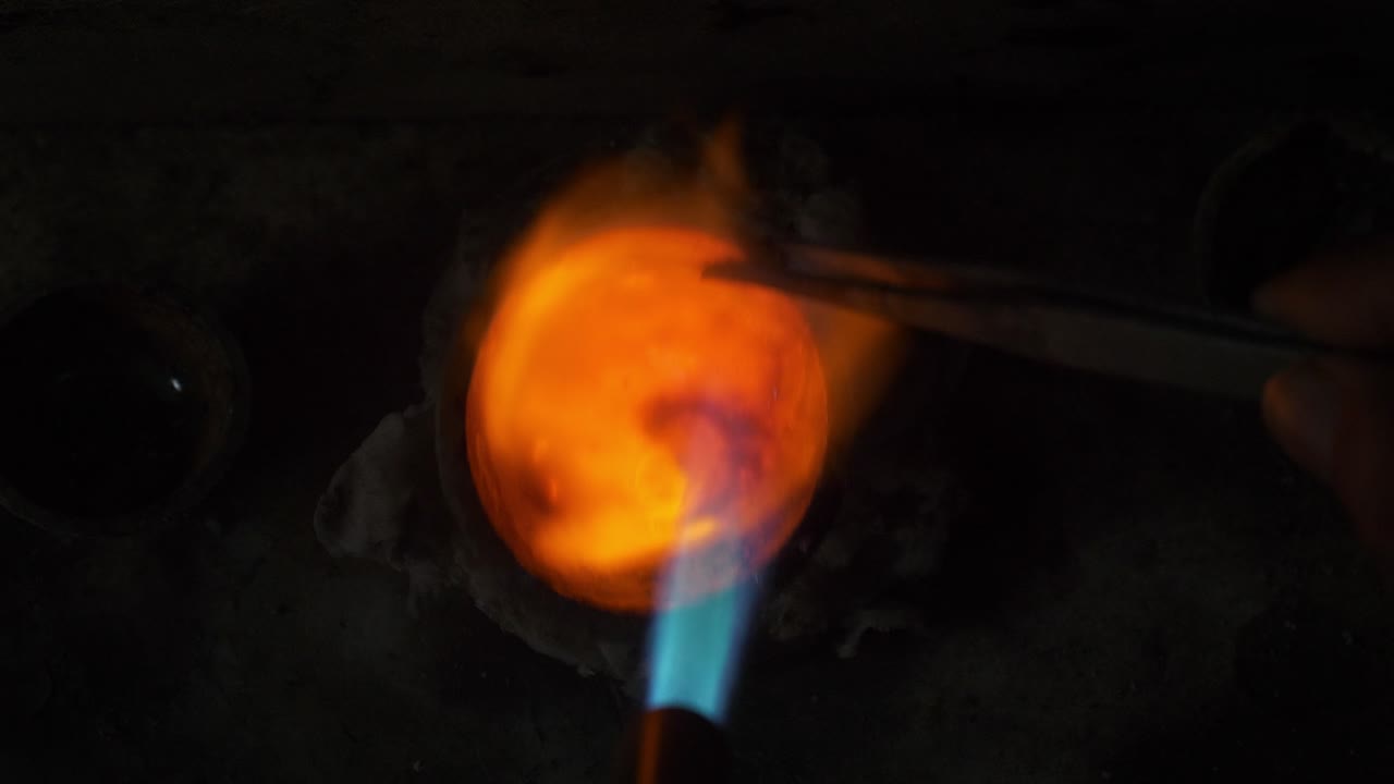 Gold melting in a furnace using fire, Goldsmith workshop, closeup