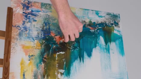 closeup the hand of a female artist paints an oil painting with butterflies closeup the hand of a female artist paints an oil painting with butterflies