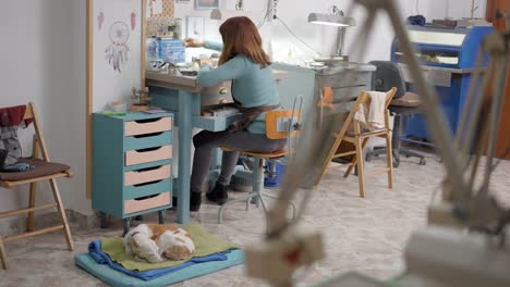 jeweler at work with her dog