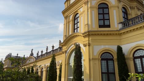 luxurious hotel with picturesque grounds of plants under a beautiful blue sky