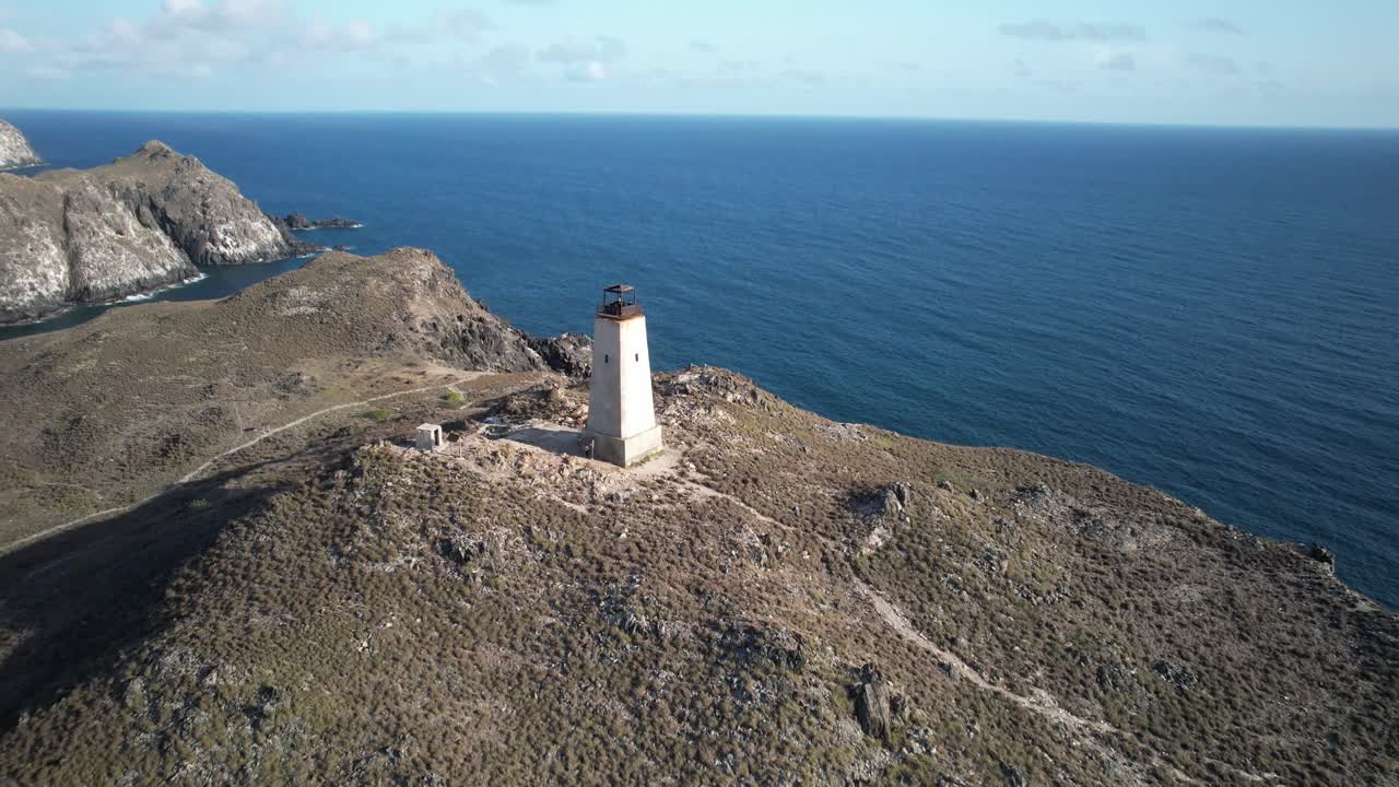 A remote lighthouse on a rocky island coastline in los roques, venezuela, aerial view