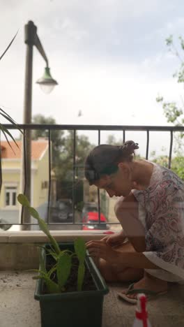 woman gardening on balcony with cactus plants