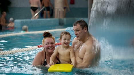 grandparents and a grandson in the swimming pool