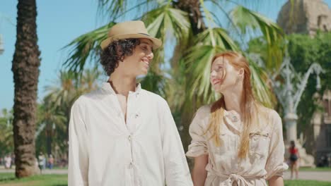 Close-up-happy-couple-looking-camera-outdoor.-Man-and-woman-smiling-each-other