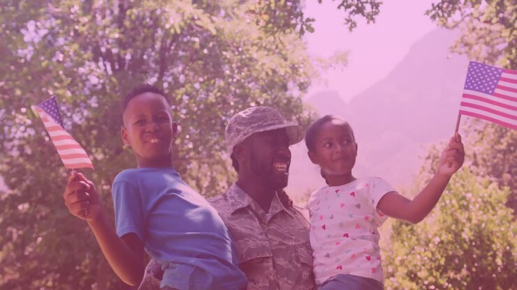 African american father in soldier uniform carrying his son and daughter in the garden