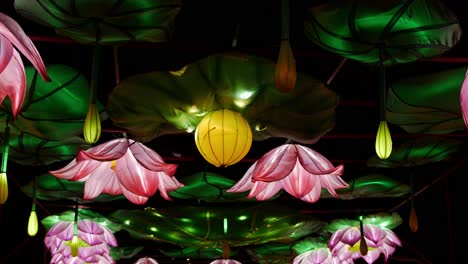 pink flower lights hang from a ceiling as yellow lights create the perception of movement