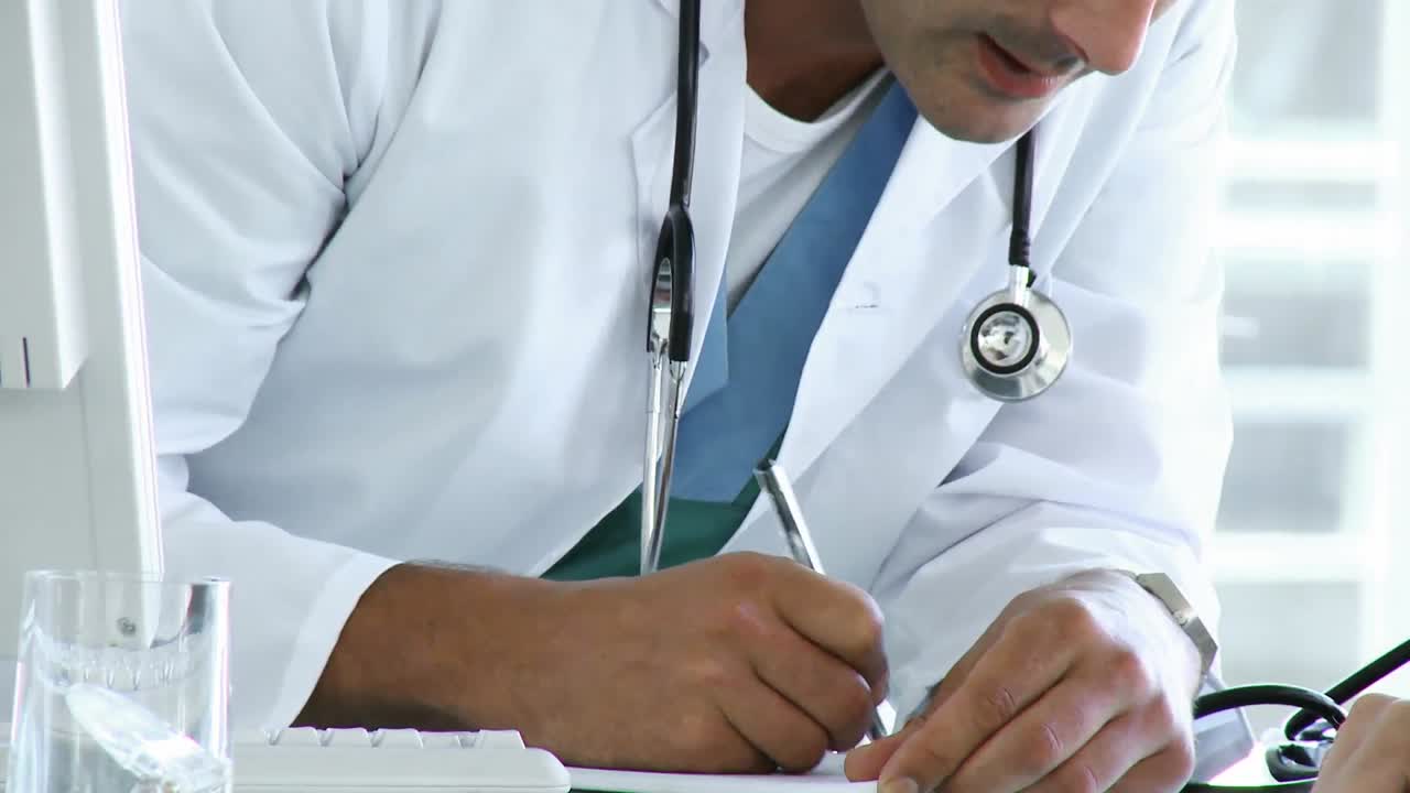 Portrait of doctor writing a prescription