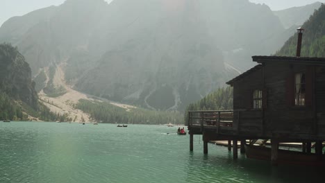 boathouse at beautiful alpine lake with mountain in background