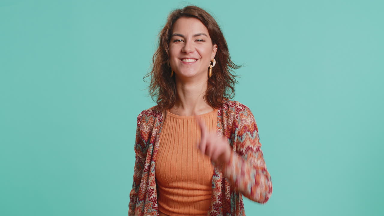 Young caucasian woman pointing finger to camera making winner choice showing direction