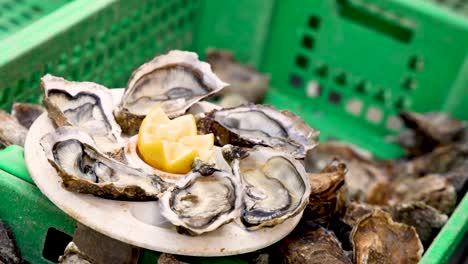 oysters and lemon in green basket