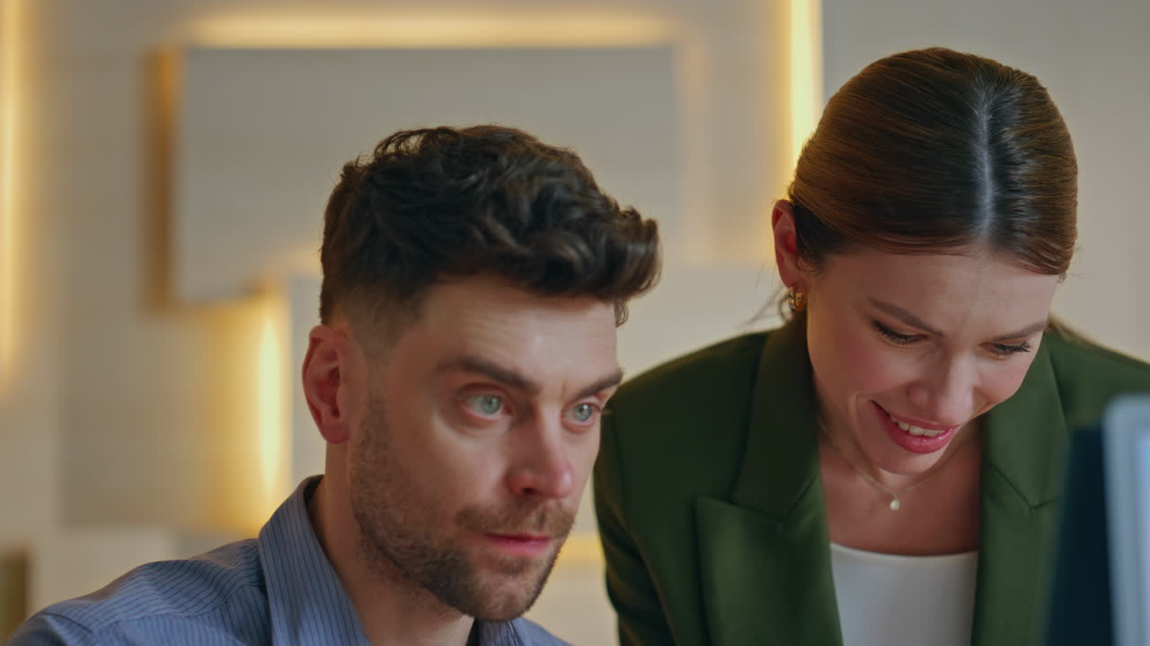 Two coworkers looking computer monitor creating project together close up.