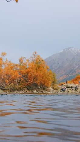 autumn landscape with mountain river and people