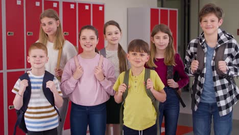 video of group of smiling children standing in the school corridor