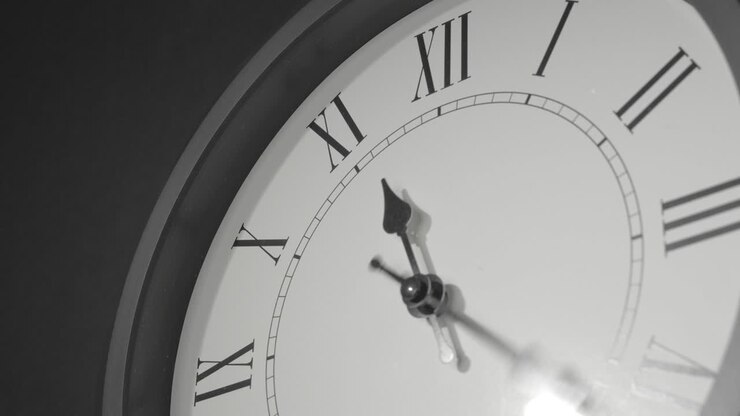 Latin Clock Face in Time Lapse on Dark Grey Wall