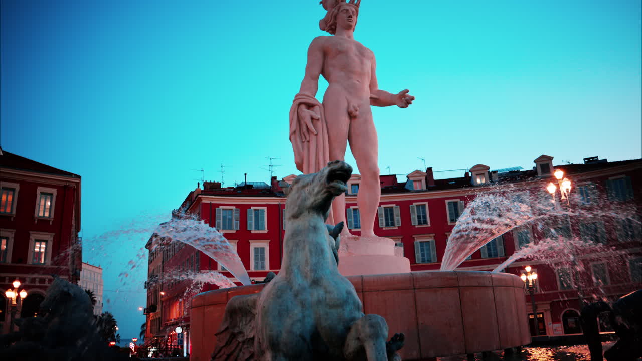 Nice, France - October 8, 2024: Apollo statue in the Fontaine du Soleil at Place Massena in the evening