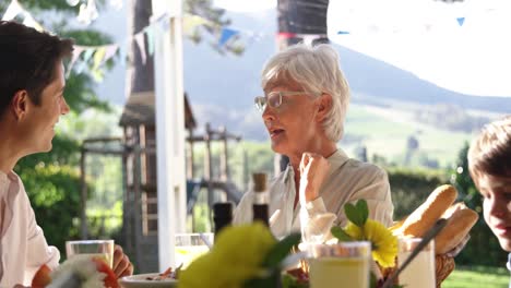 family eating outside together in summer
