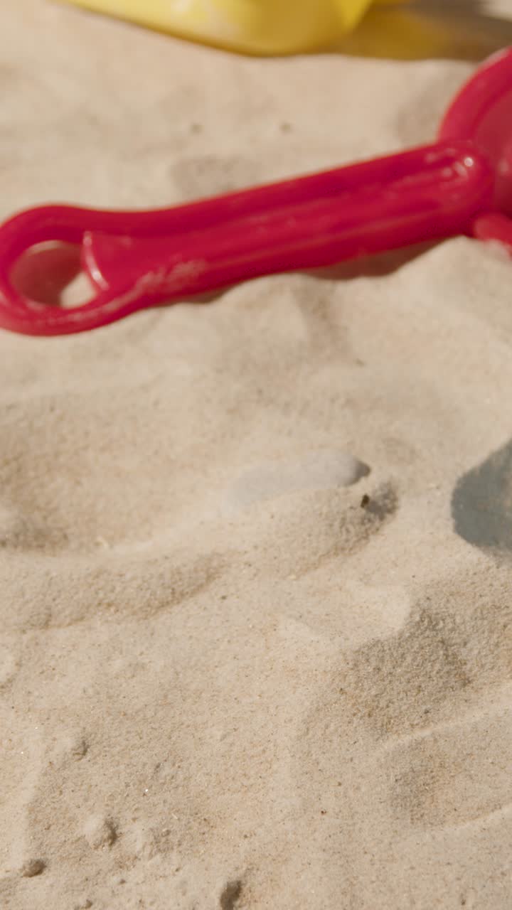 Vertical Video Summer Holiday Concept With Child's Toys Bucket And Spade On Sandy Beach