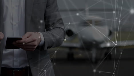 animation of network of connections over caucasian businessman using smartphone