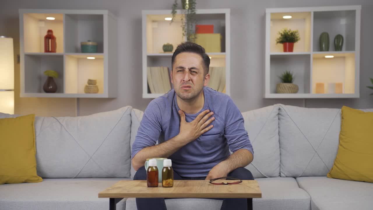 The sick man can't stop coughing.