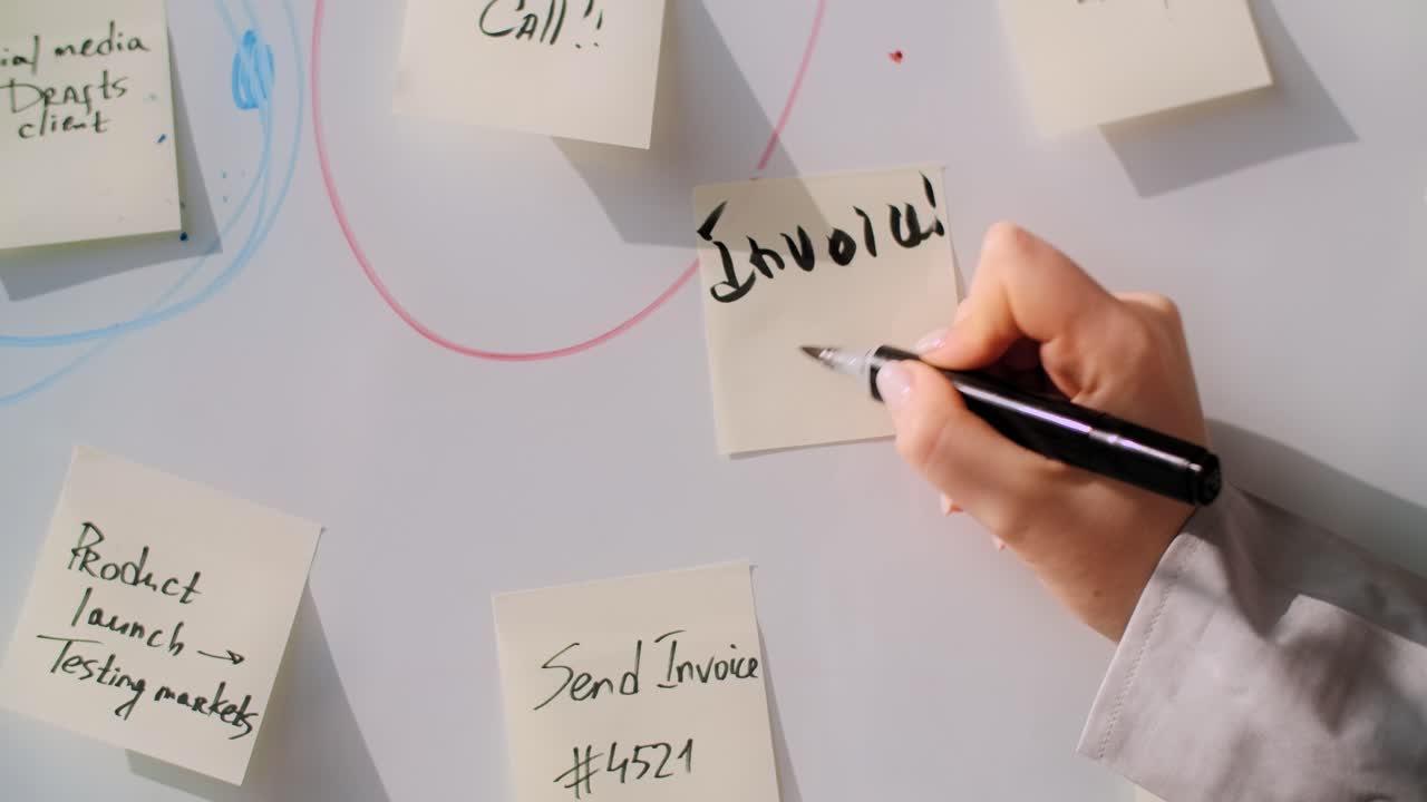 Woman writing invoice on whiteboard