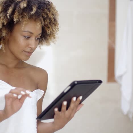 woman using tablet computer in the bath